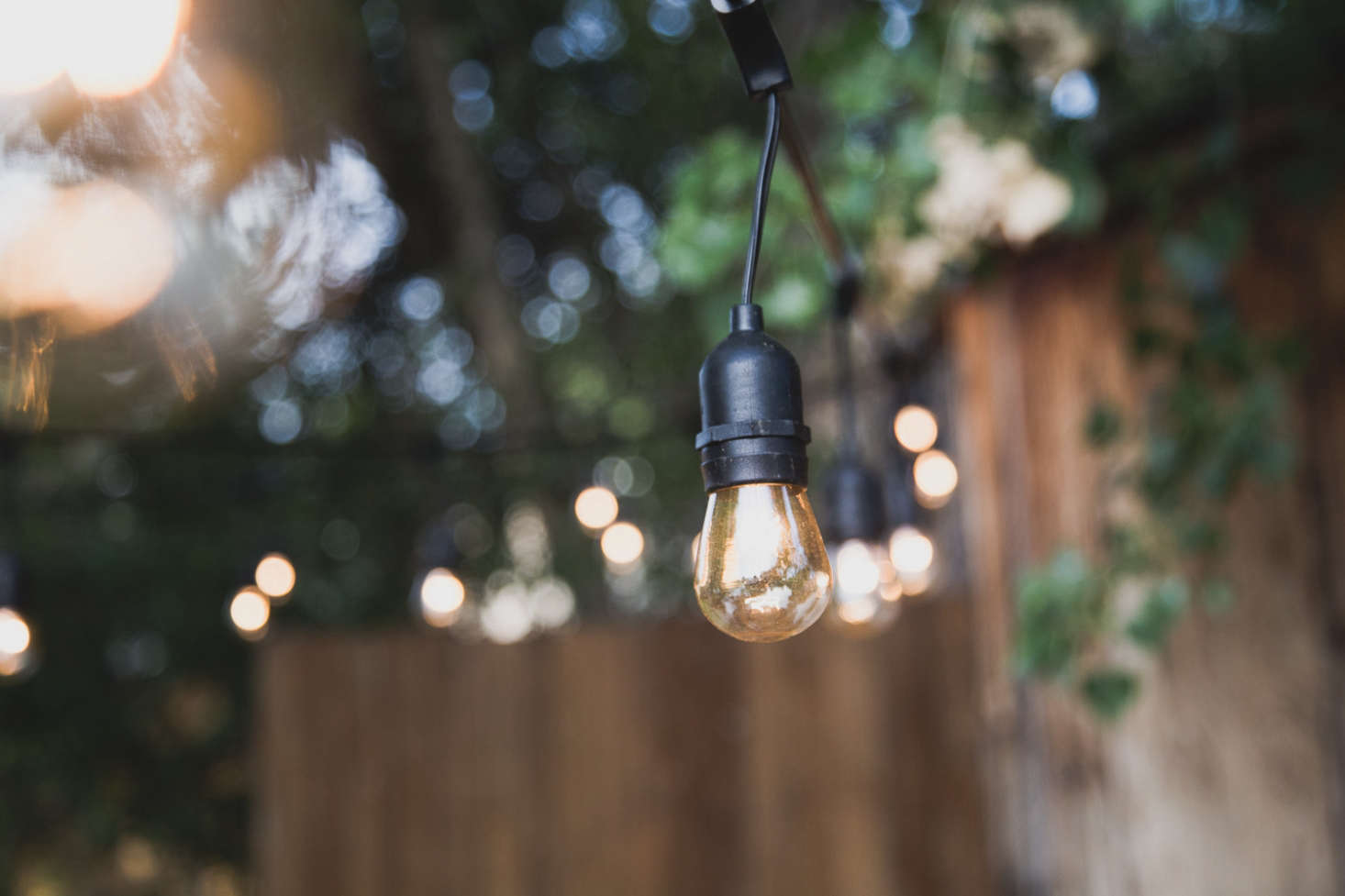 Four strands of Sokani -Foot-Long Outdoor Lights, $.99 each via Amazon, hang from the metal poles.