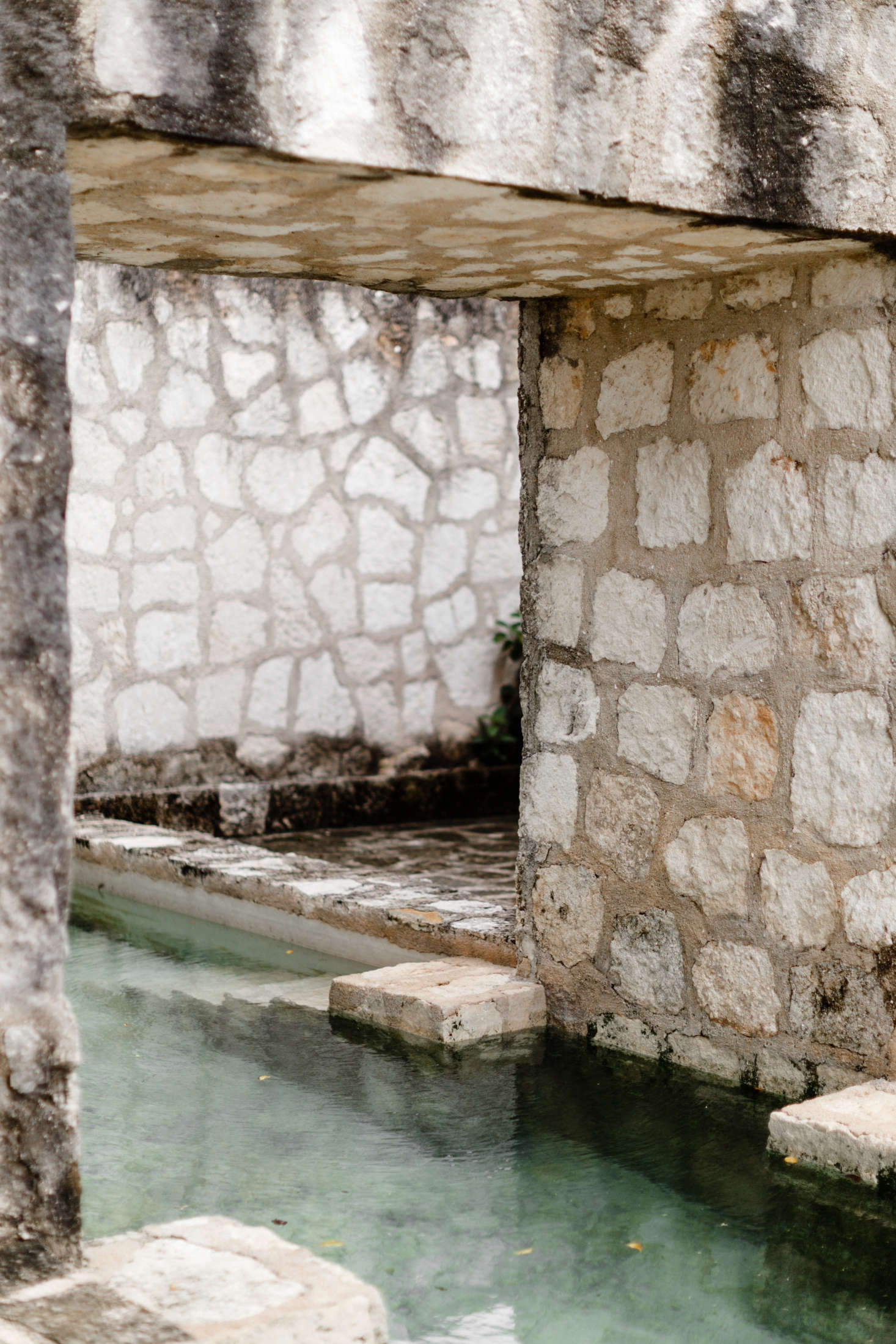 Narrow stairs descend into the water.