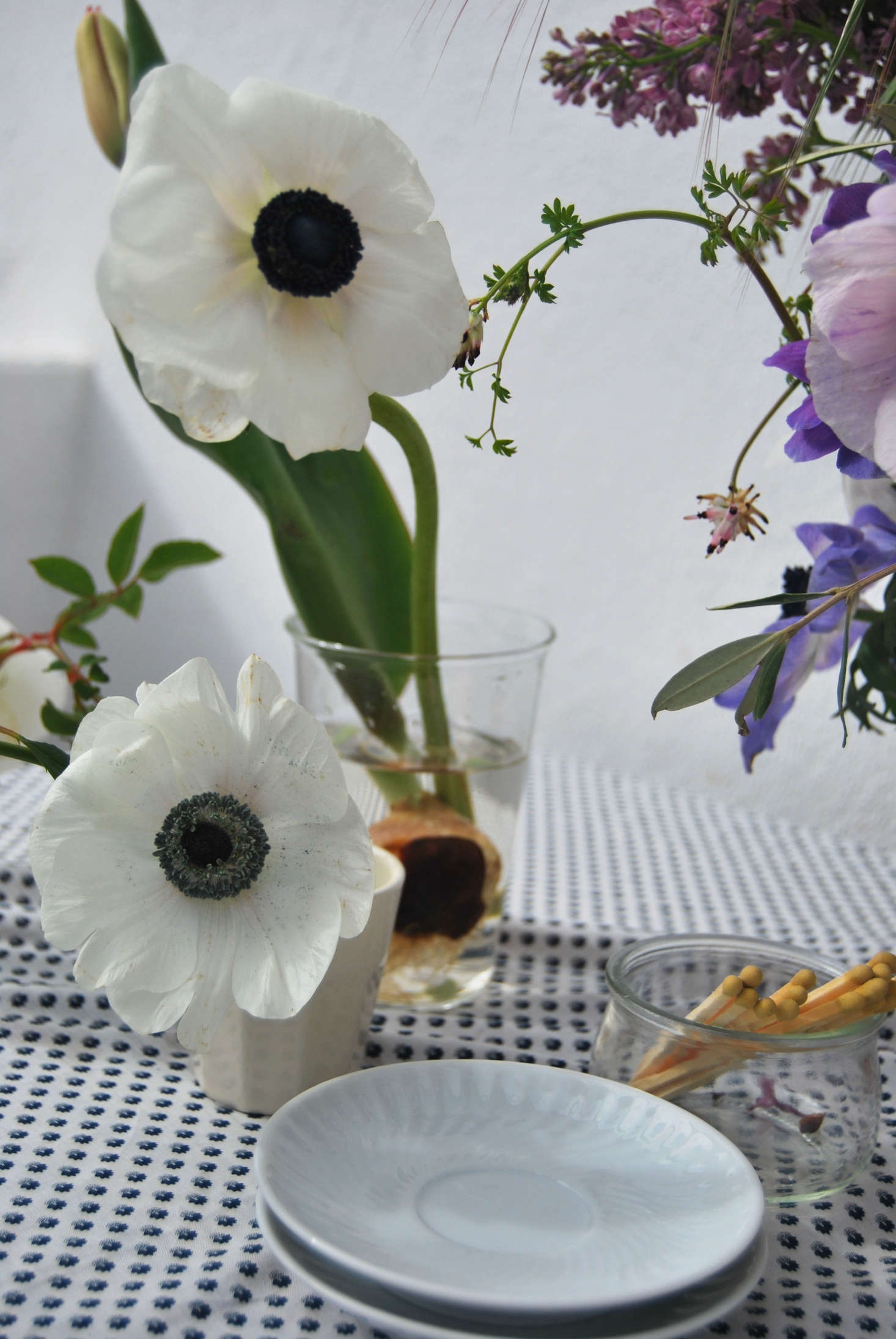 Stems of anemone paired with tulip and rambling roses.