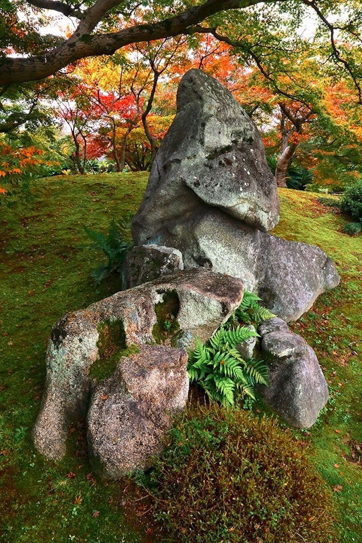  Instead of a sculpture, consider the judicious selection and placement of a beautiful rock. (Yours might be a little smaller than this one.)