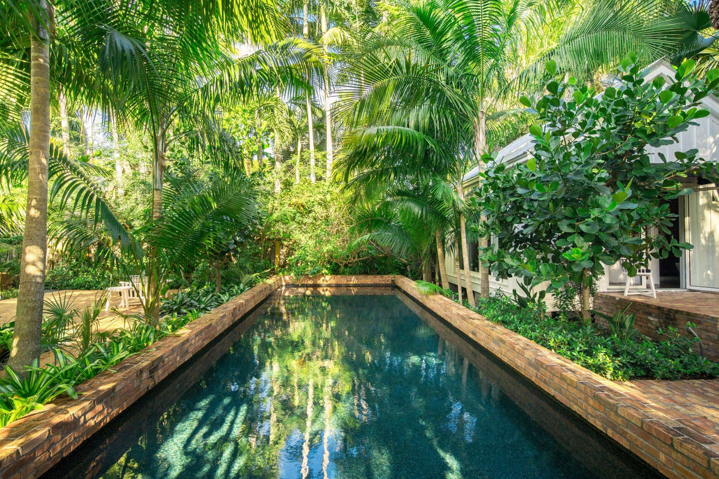 Visible at right is the guesthouse, which has doors that open onto the pool. The homeowners 