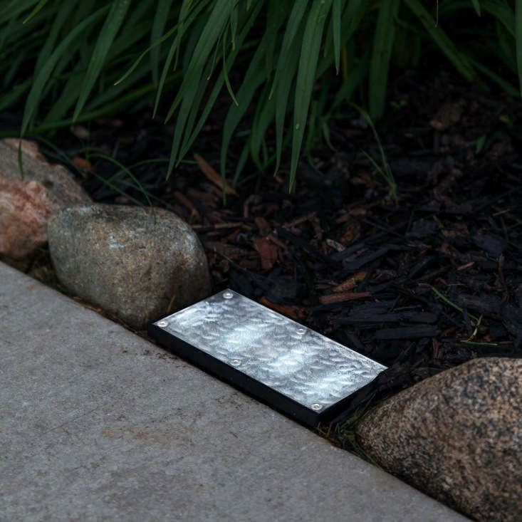 An 8-by-4-inch Solar Landscape Paver Brick Light comes with an embedded solar panel and rechargeable battery. It is \$35.99 from Lamp Lust via Amazon.