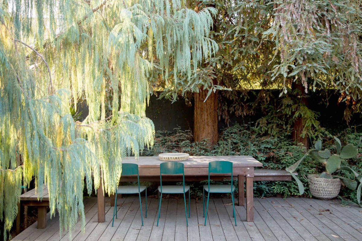 A a dining platform with redwood decking (and built-in bench) is a natural complement to mature redwood trees in a garden in Los Angeles (also shown in the top photo). See more in Before & After: From Desert to Redwood Forest, the Essence of California in One LA Garden. Photograph courtesy of Terremoto.
