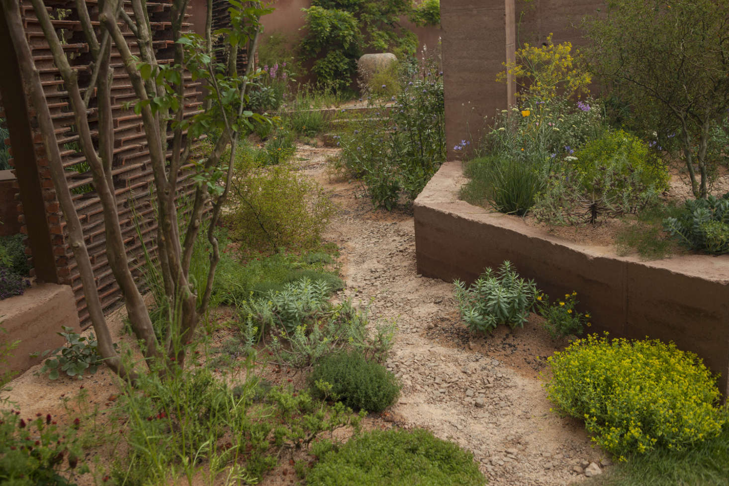 Rammed earth walls, screens, and pillars were put together on-site during the show build.