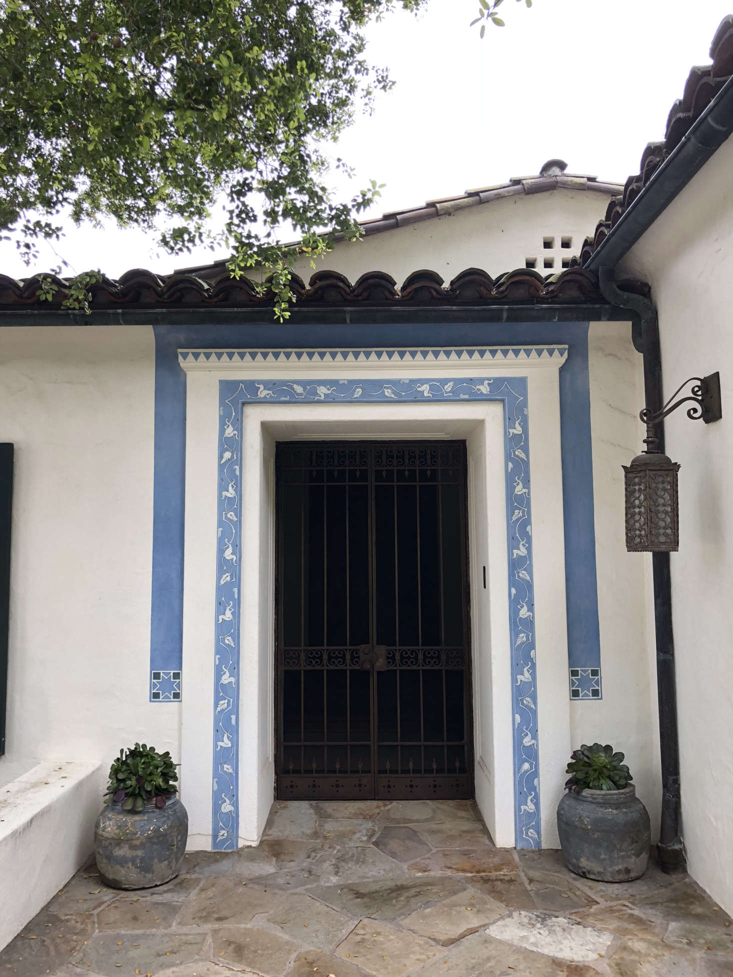 The entryway, with the original tile work and flagstone path preserved. Sosa and Gonzalez 