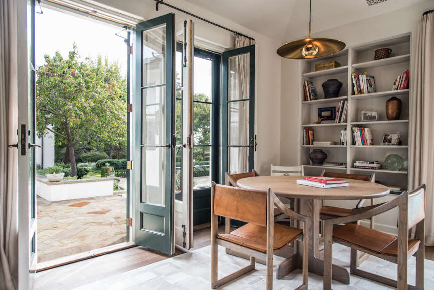 The house is designed for indoor-outdoor living. Throughout, double doors open from the remodeled interiors onto the surrounding grounds.