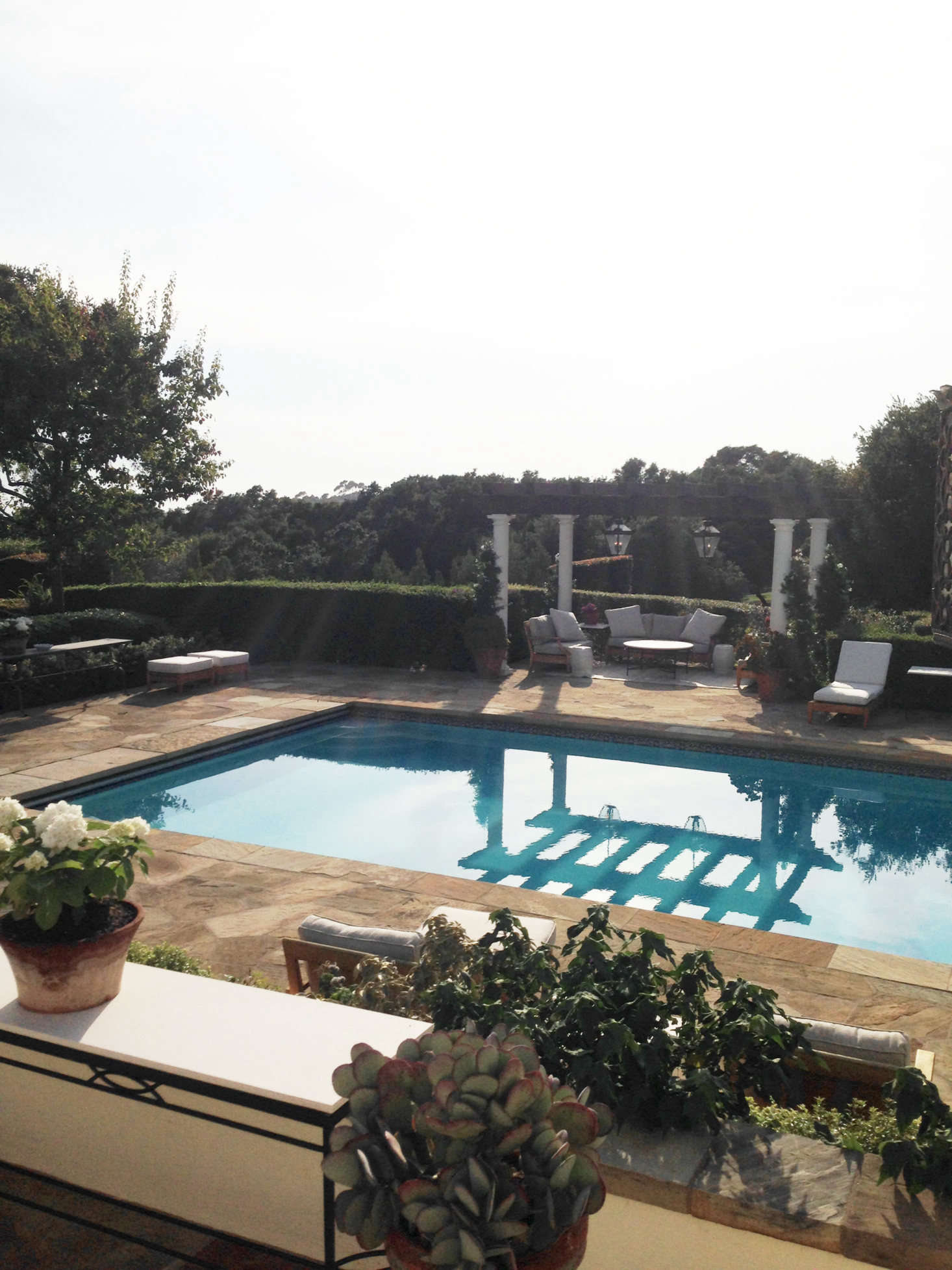 Elsewhere on the grounds is the luxe outdoor pool, bordered by a hedge, for privacy. 