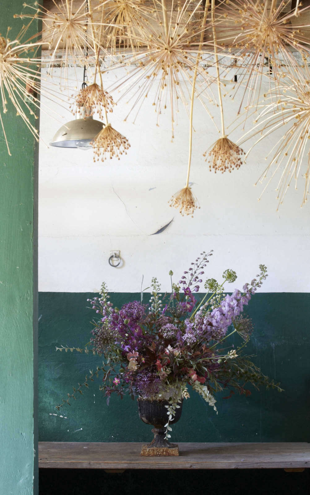 In the workroom at Bayntun Flowers, dried alliums hang from the ceiling.