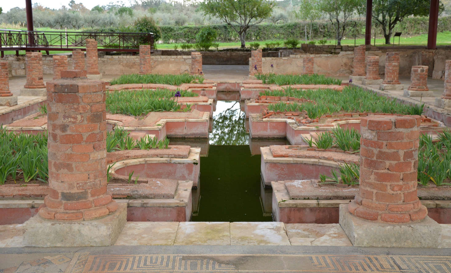 Roman ruins reveal the remains of columns in a peristyle garden at Conímbriga. Photograph by Carole Raddato via Flickr.