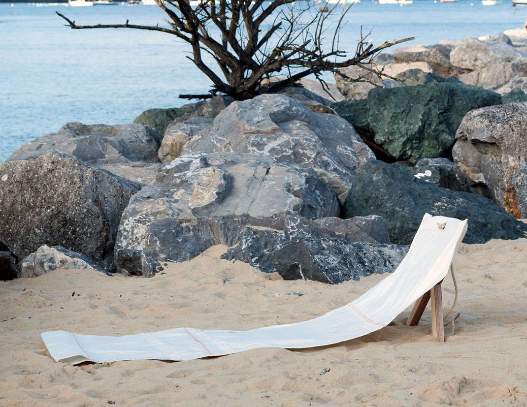 The ingenious Fortuna design, $0, has a wooden support that sinks into the sand. When not in use, the sailcloth rolls up into a rope-tied package with the legs stored in the sleeve at the bottom.
