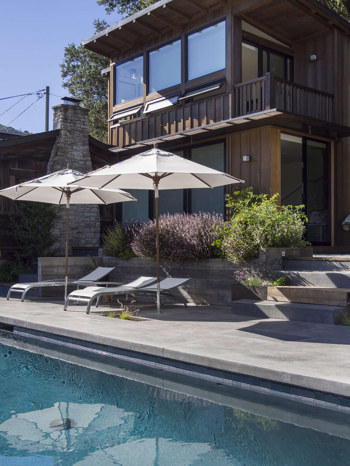 Two in-ground umbrellas provide poolside shade as needed.
