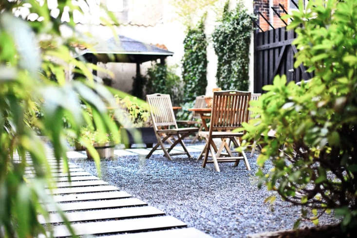 Narrow and long, stone paver strips mimic the look and feel of a beach boardwalk in the garden at Bertrams Guldsmeden hotel in Copenhagen.