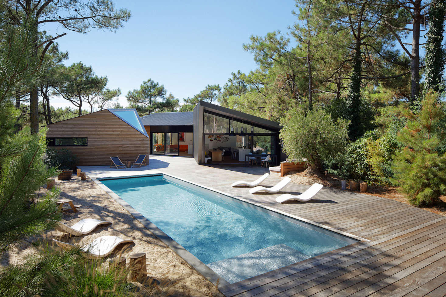 The grand vision for the estate is a series of cabins linked by a wooden terrace to a body of water: the swimming pool.