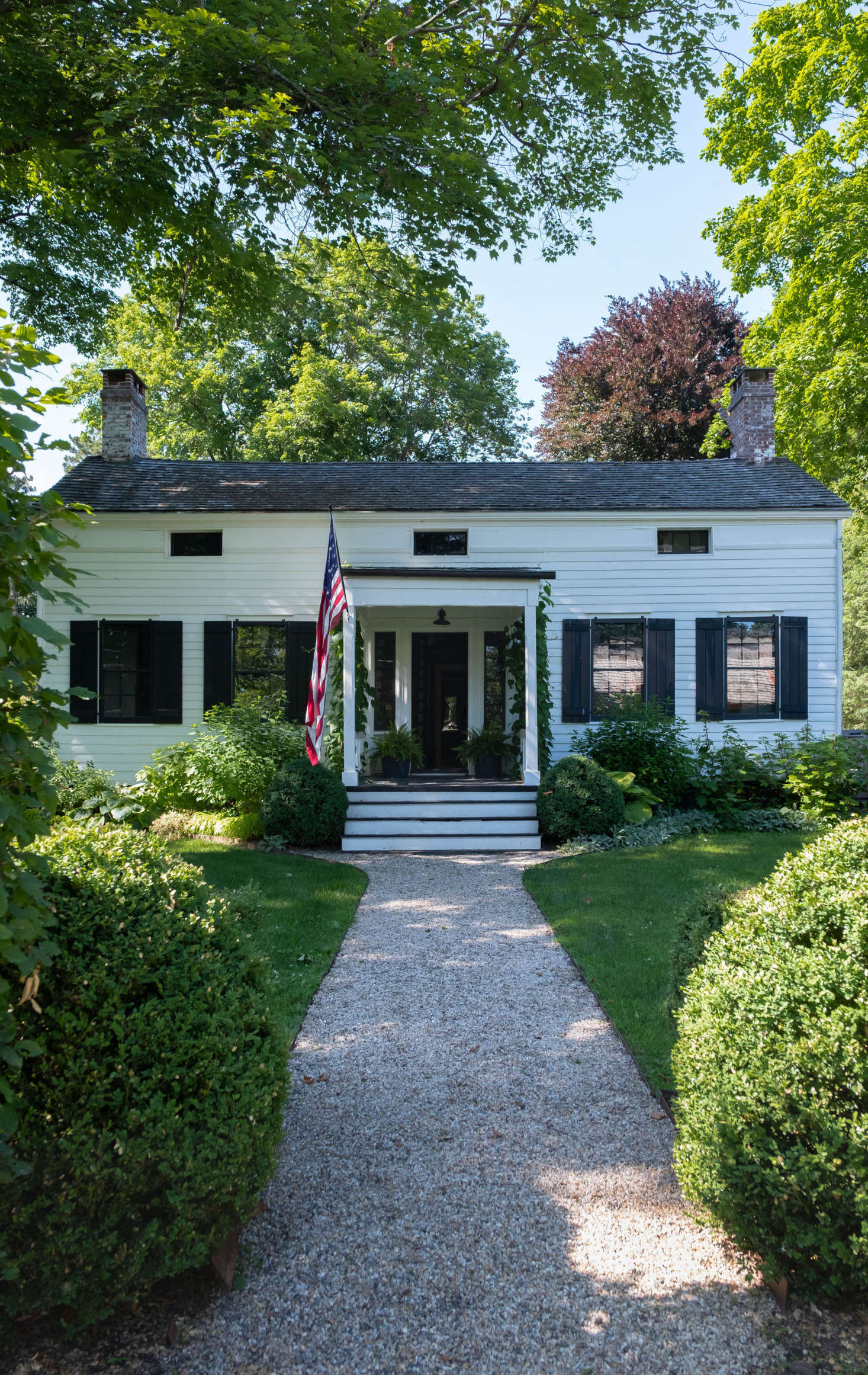 The circa-30 house is set back from a main street in Claverack, where tall hedgerows abut the road and conceal the historic houses and sprawling gardens behind.