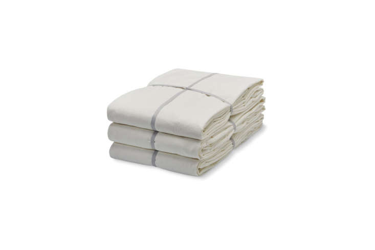 One of many good choices for simple white bedsheets is the Merci Milky White Cotton Fitted Sheet (available seasonally) and accompanying Milky White Cotton Flat Sheet (also available seasonally). For more options, see our post \10 Easy Pieces: Simple White Sheets.