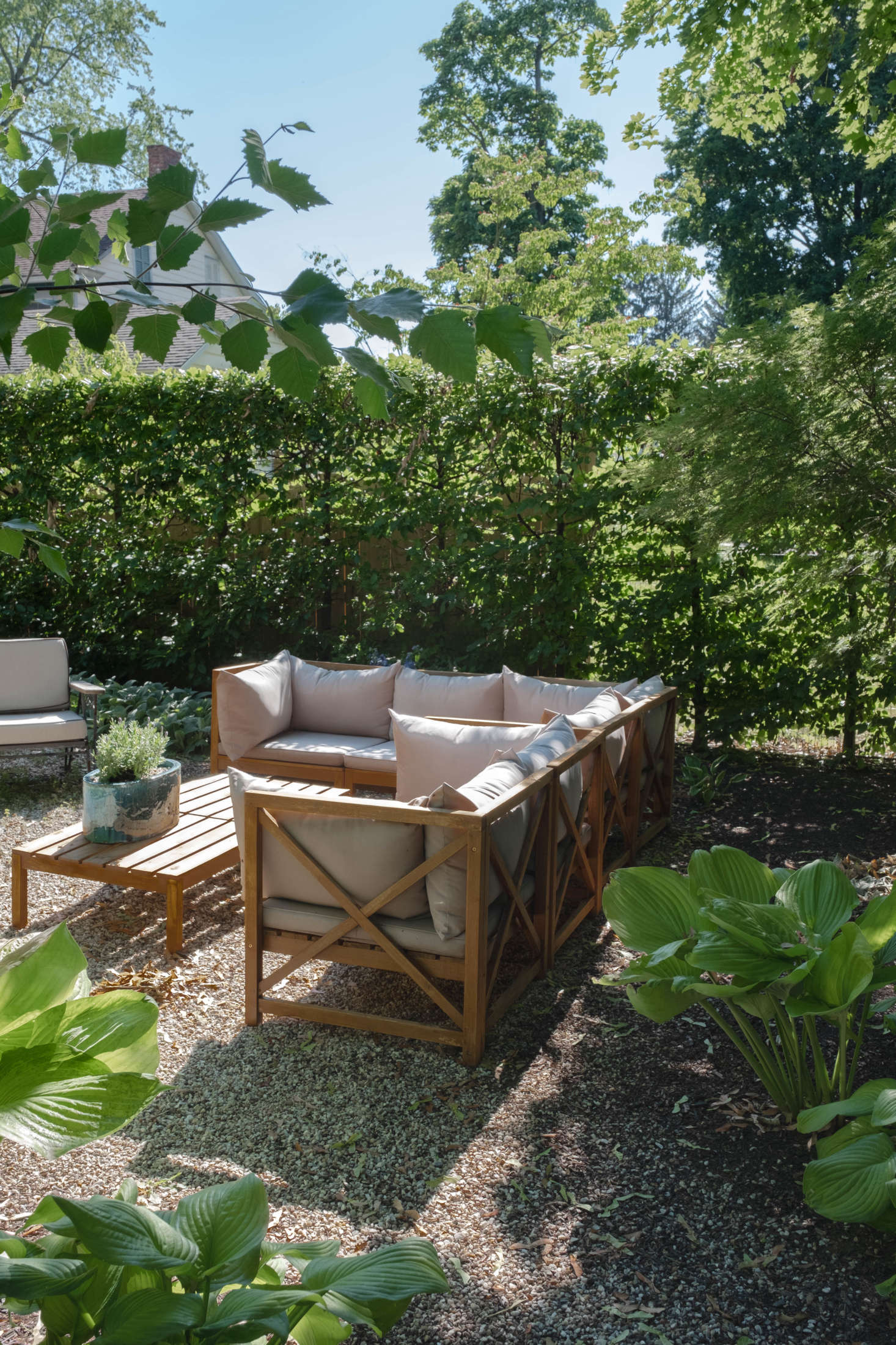 A summer living room, set for lounging. The outdoor furniture was all in place when the couple moved in.