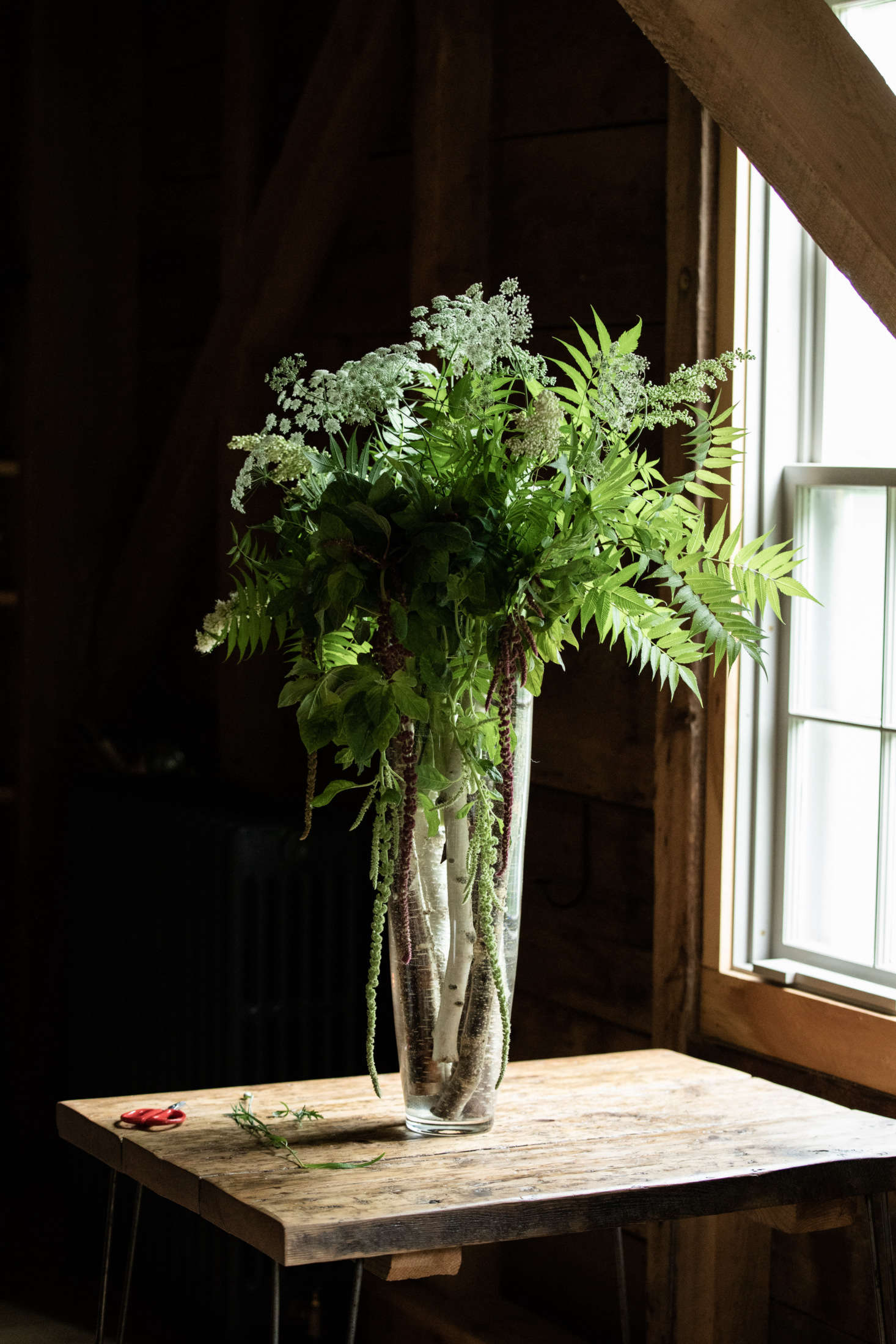 French starts every arrangement with a few birch logs in the bottom of the vase, which add a woodsy touch and help anchor the large, heavy arrangements to the table. She collects them from the side of the road 