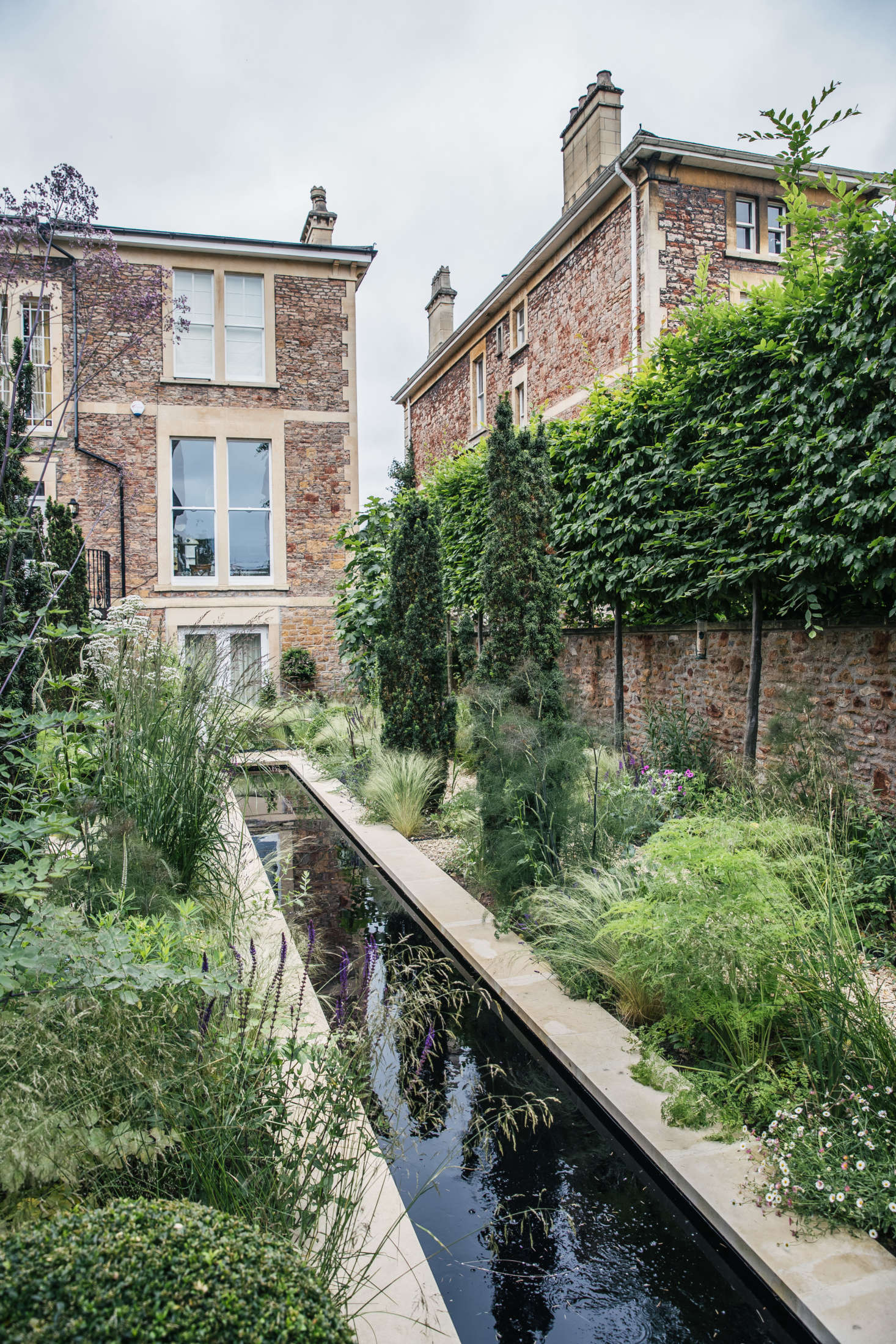 A long, slim reflecting pool is one of two major water features in the project. 