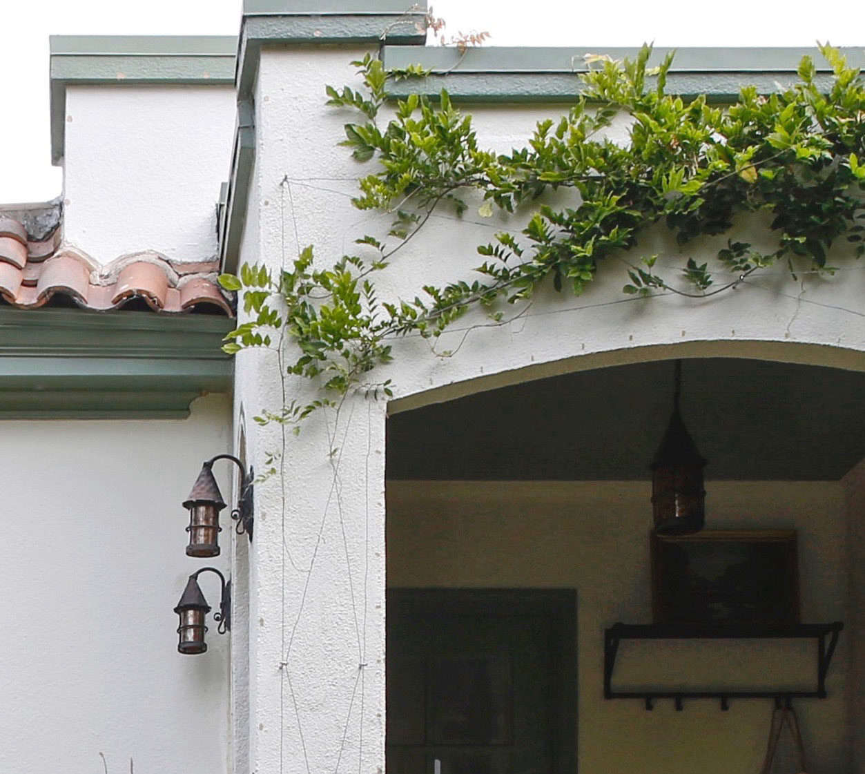 Dabs of silicone left behind telltale blemishes on the stucco. You can see where the holiday lights were affixed to the facade above the arch.
