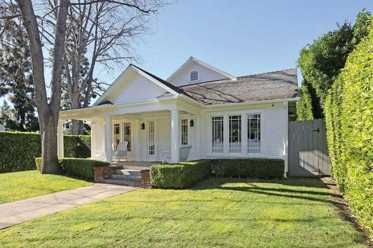 A white-on-white facade on a three-bedroom bungalow in Hollywood that Lena Dunham bought in \20\15. See more in \10 A-List Garden Ideas to Steal from Hollywood Celebrities. Photograph via MLS.