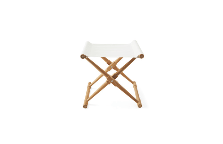 A Teak Camp Stool available in three colors (shown in white) has a canvas seat made of double-sided, all-weather Sunbrella fabric; \$\2\28 at Serena & Lily.