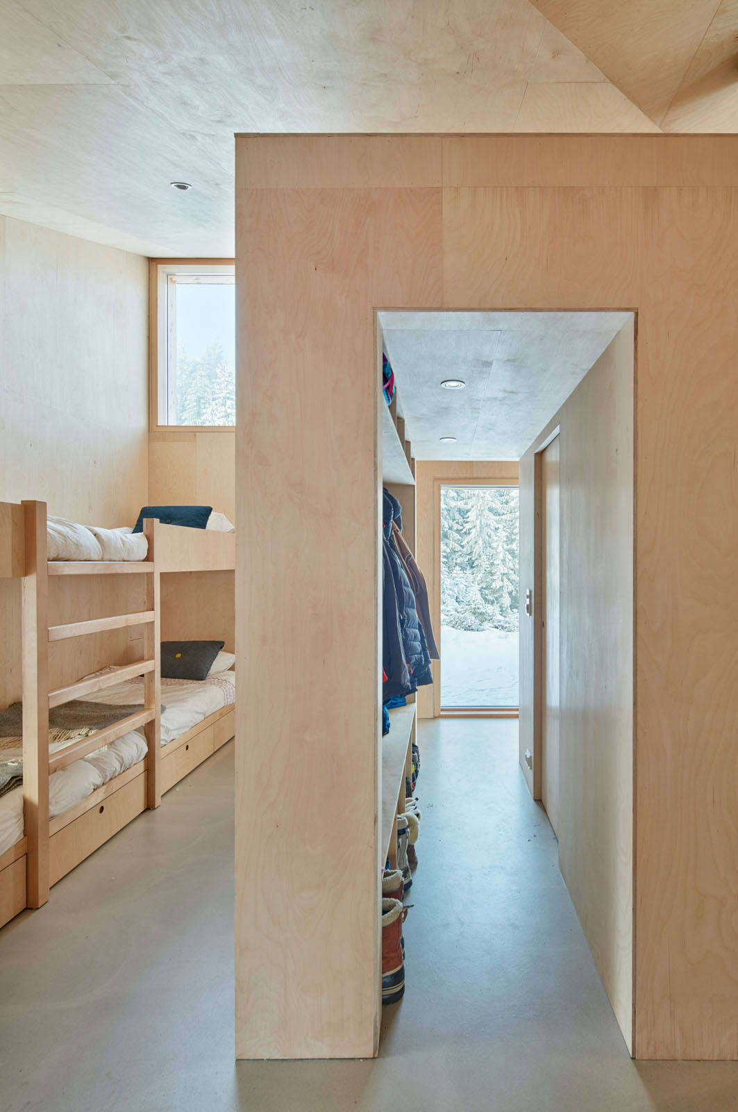 Windows in the bunkroom frame the woodland views. 