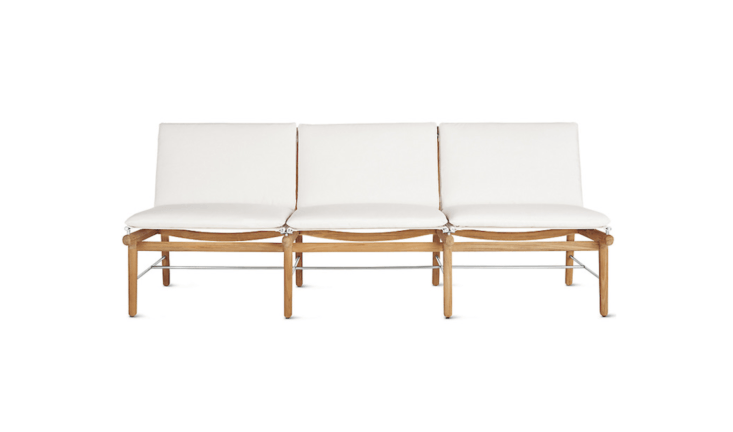 A a 76.5-inch-long Finn Three-Seater Sofa from Danish design house Norm has a teak frame and mildew-resistant Sunbrella cushions (available in white or black); \$\2,795 at Design Within Reach.