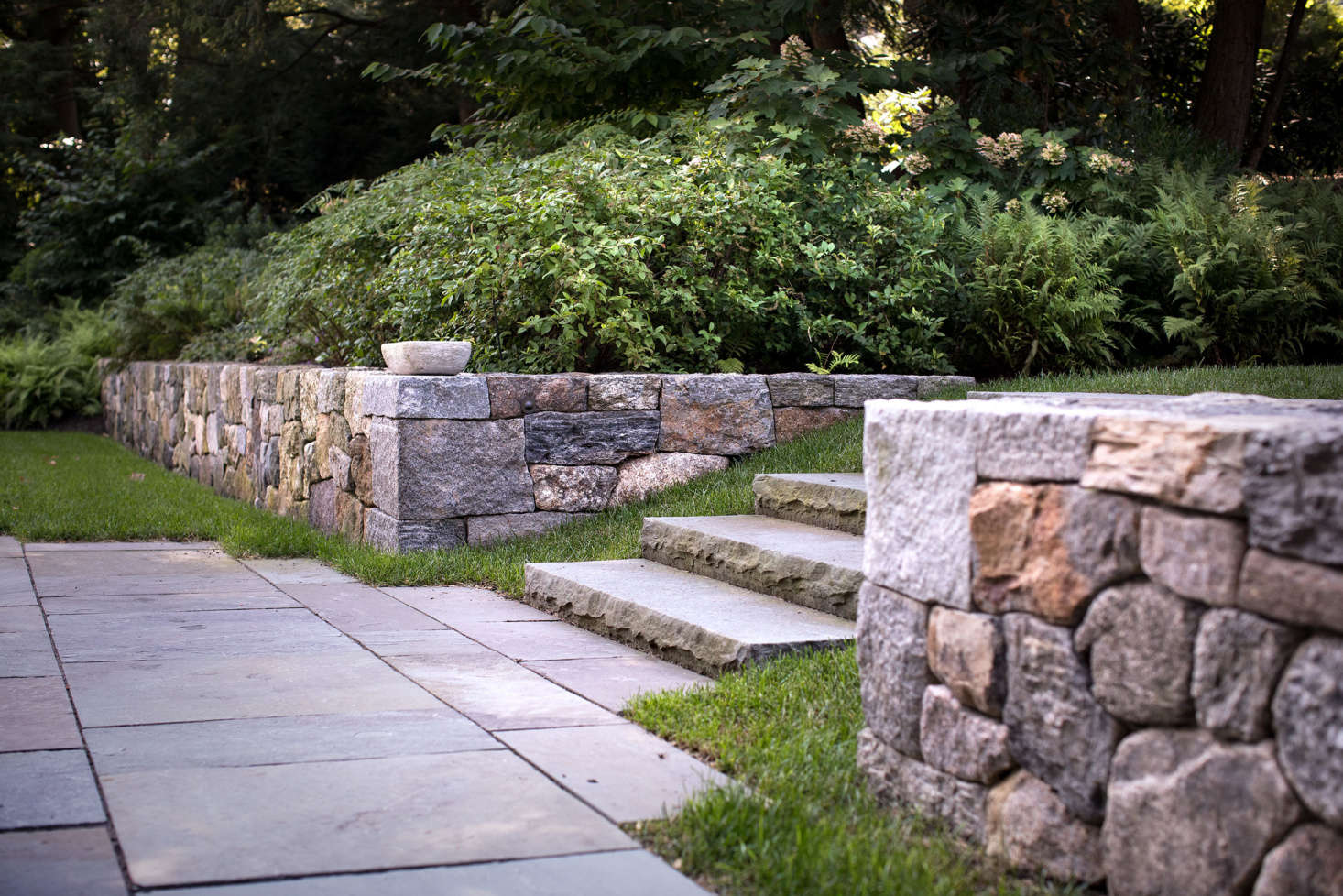 Salvaged granite, puddingstone, and Massachusetts fieldstone were used to in all the retailing walls throughout the property.
