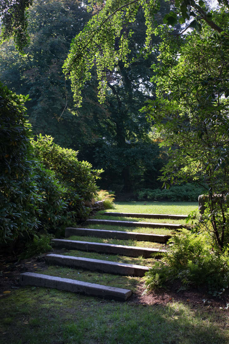 Completing the circuit around the yard, another set of inlaid stone steps leads towards the front of the house.