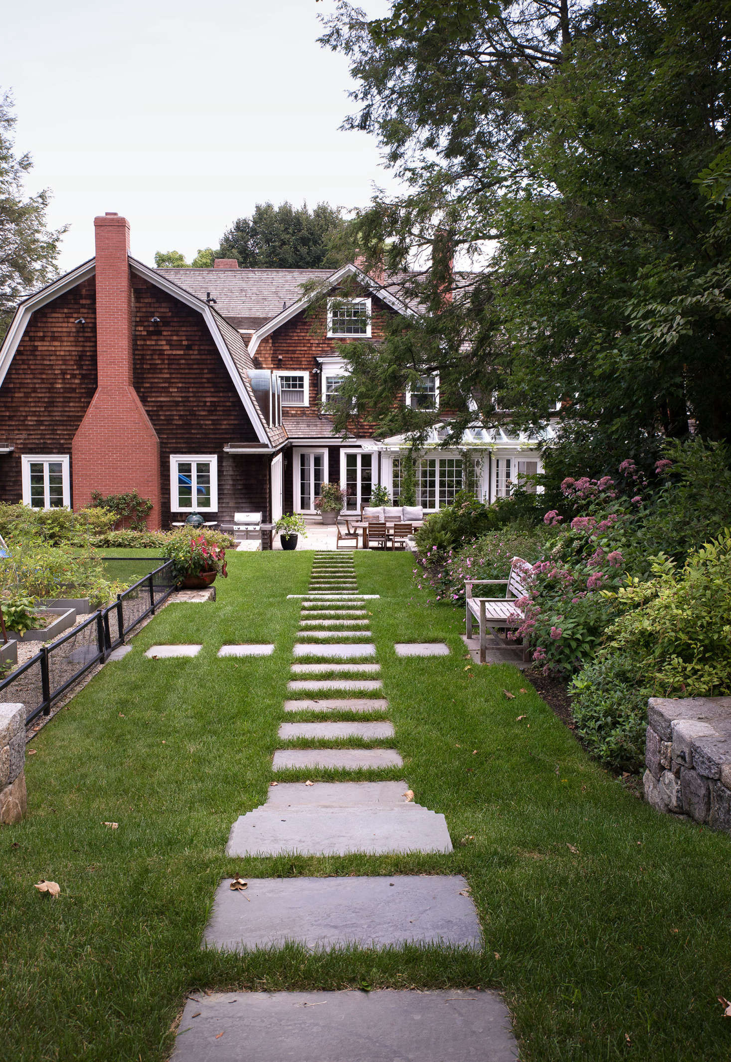 To create the series of gently stepped terraces, tons of dirts was hauled away. Then, to connect each of the various levels visually and structurally, Bob