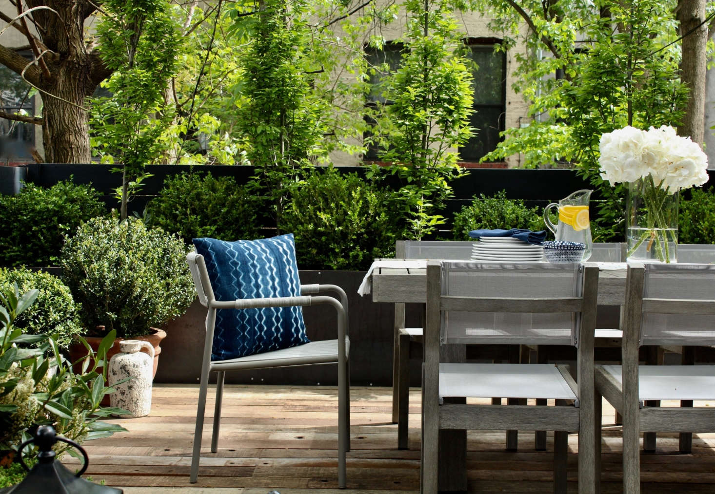 Taller elements, such as the trees planted along the back fence, provide privacy in a city garden.