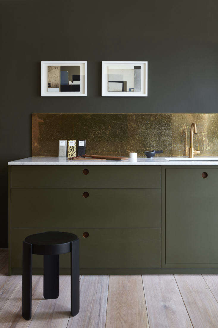 Pre-aged with a hand-applied splatter pattern, a brass backsplash (also shown in the top photograph) &#8\2\20;is lacquered with a &#8\2\16;non-porous coating to protect from continued tarnishing and fix the patina.'&#8\2\2\1; writes Margot. Photography courtesy of Naked Kitchens.