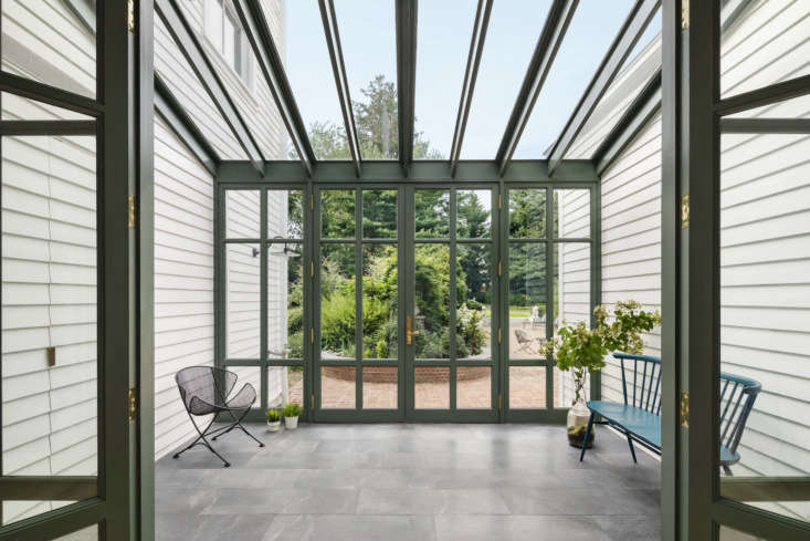 In a house in Larchmont, New York, Brooklyn firm O&#8\2\17;Neill Rose Architects worked with a palette of strong greens and a neutral base white to &#8\2\20;relate to the lush greenery that surrounds the house,&#8\2\2\1; they say. Shown here in the greenhouse, Benjamin Moore Caldwell Green (HC-\1\24) &#8\2\20;draws in the garden beyond and unifies the blue-gray schist of the greenhouse floor and brick ground plane beyond.&#8\2\2\1; The architects tested a variety of whites for the exterior by painting swatches at each light exposure and observing the color throughout the day. &#8\2\20;This was the white that responded the best to all light conditions; the most natural, crisp, not too stark, but not dingy either.&#8\2\2\1; It&#8\2\17;s Benjamin Moore White Heron (OC-57). Photograph by Michael Moran courtesy of O&#8\2\17;Neill Rose Architects.