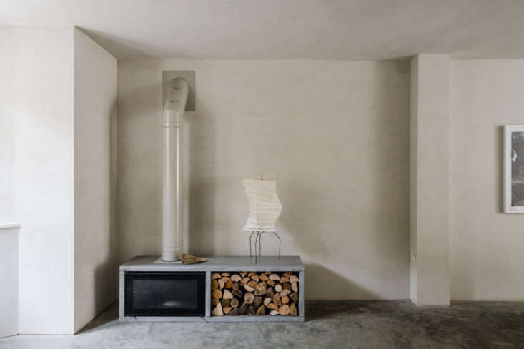 A Noguchi lamp is the perfect and only decoration in this little corner occupied by a Stovax wood-burning stove. See A Tale of Two Styles: Proper Victorian on the Outside, Modern Zen on the Inside for the rest of the exquisite home. Photograph courtesy of The Modern House.