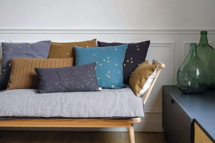 Take a page from the French and cover the seat of your sofa with a characterful throwbed. See 7 Favorites: Soft, Stylish Throwbeds (Starting at \$50).