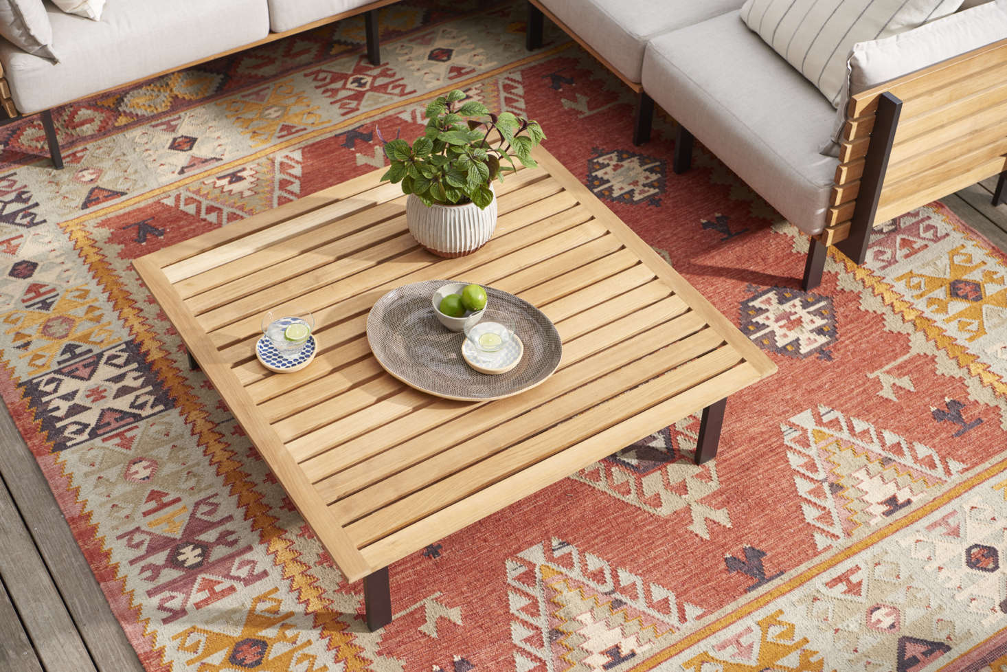 Set the Jasper Teak Coffee Table ($599) with drinks and snacks for cocktail hour en plein air.