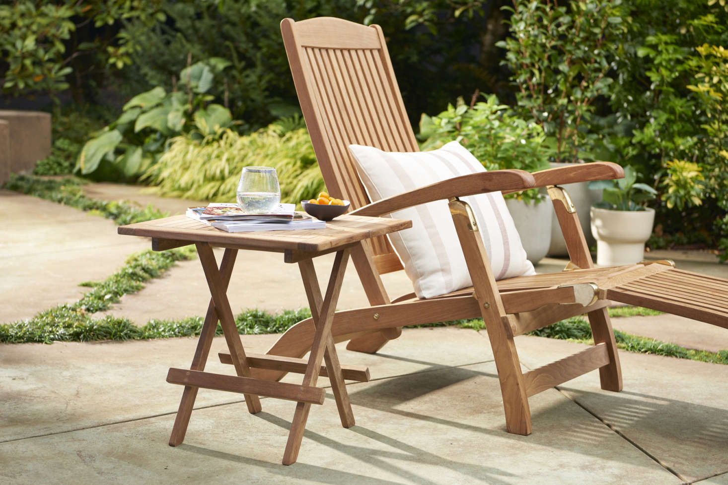 Even tiny outdoor spaces can turn into mini oases with a single Teak & Brass Folding Lounge Chair ($data-src=