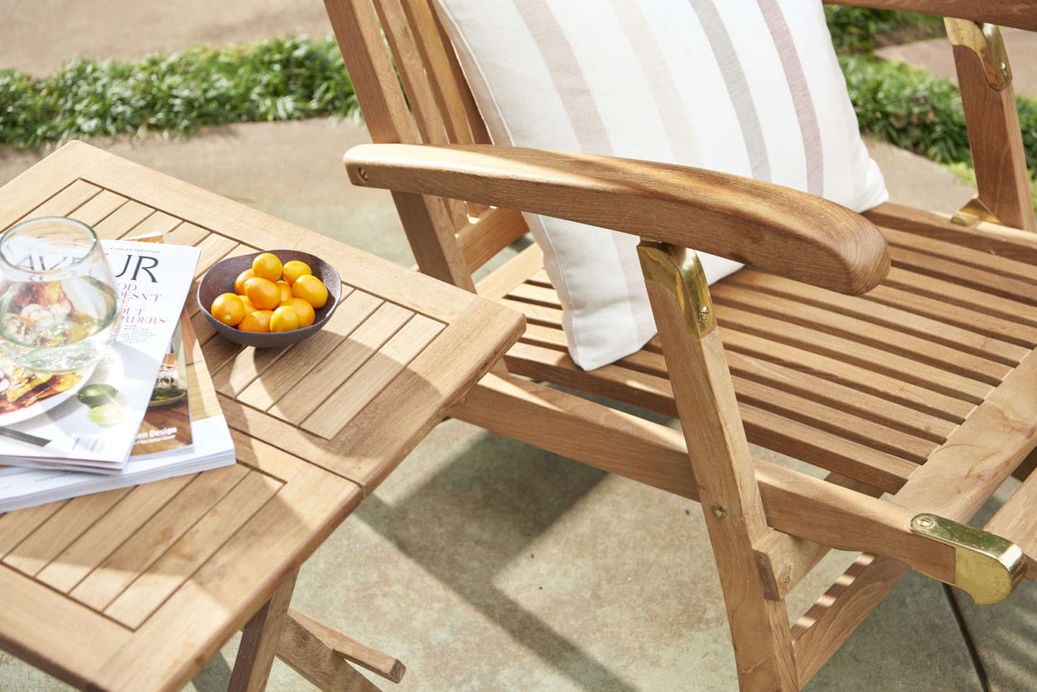 Make sure to add a Teak Folding Side Table ($9) alongside for keeping a glass of lemonade within easy reach.
