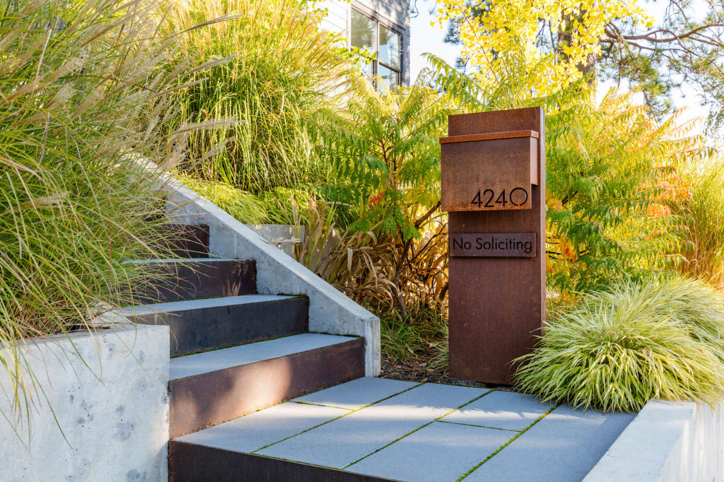 A new street-level custom mailbox clearly announces the house