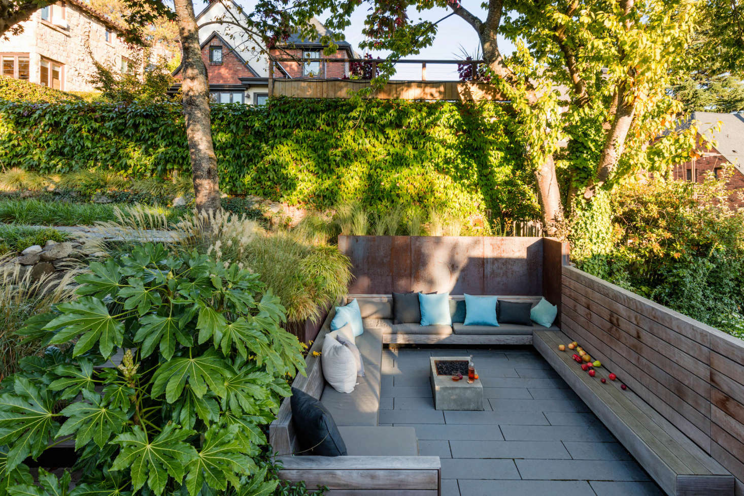 The courtyard is enclosed by plate steel retaining walls and ipe wood benches, and anchored by a fire pit.