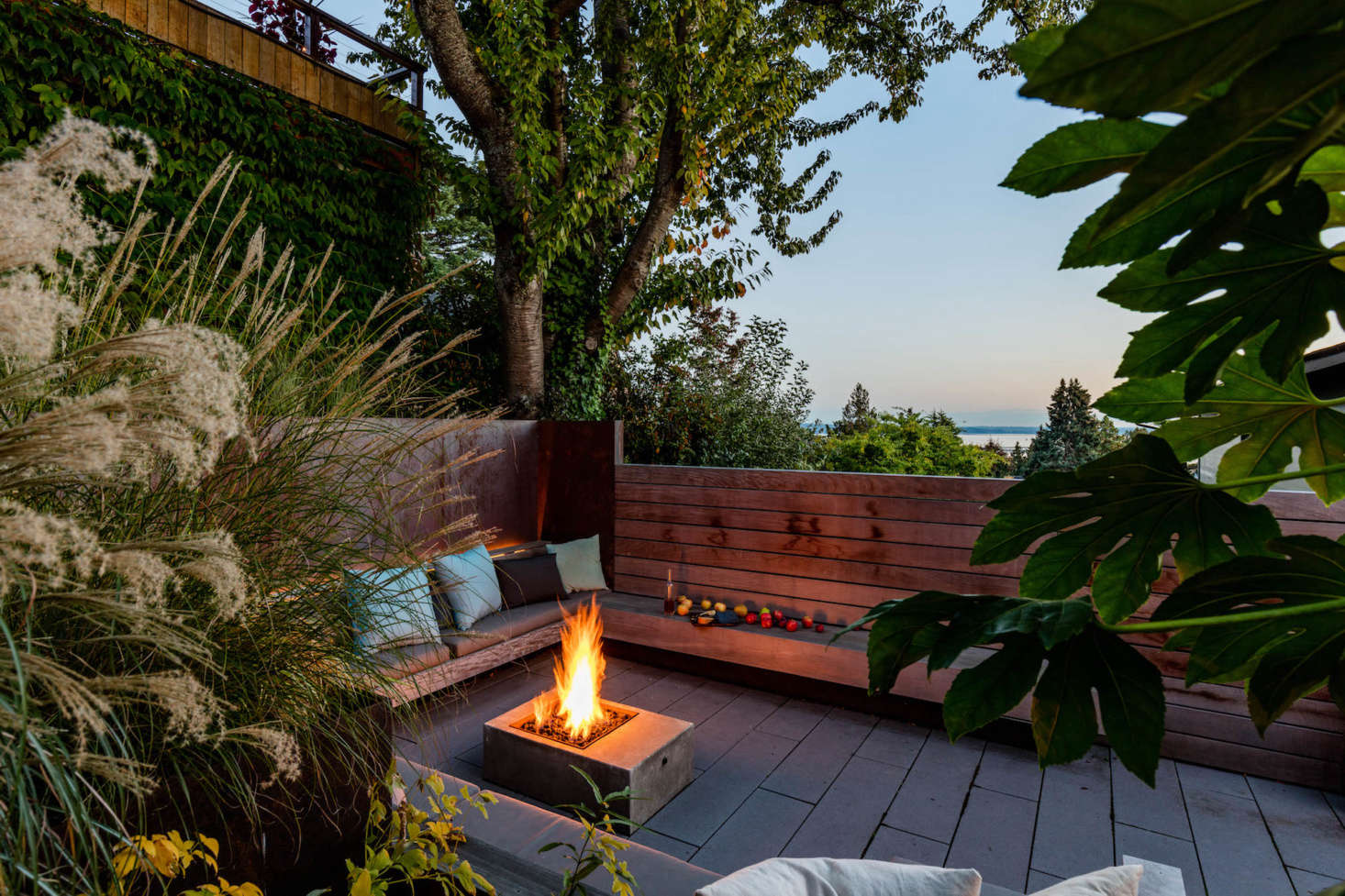 A peek of Lake Washington just beyond the wood wall. The concrete fire pit was designed by Wittman Estes.