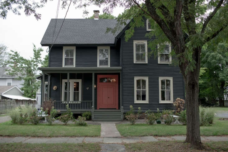 The new exterior, with new roof, new paint, new door, new porch, and new windows. &#8\2\20;I always remove shutters as a first step so I can really see the house. Often, they don&#8\2\17;t go back on. It&#8\2\17;s really about scale and proportion for me. I felt this house was too small to accommodate all those shutters,&#8\2\2\1; says Maryline.