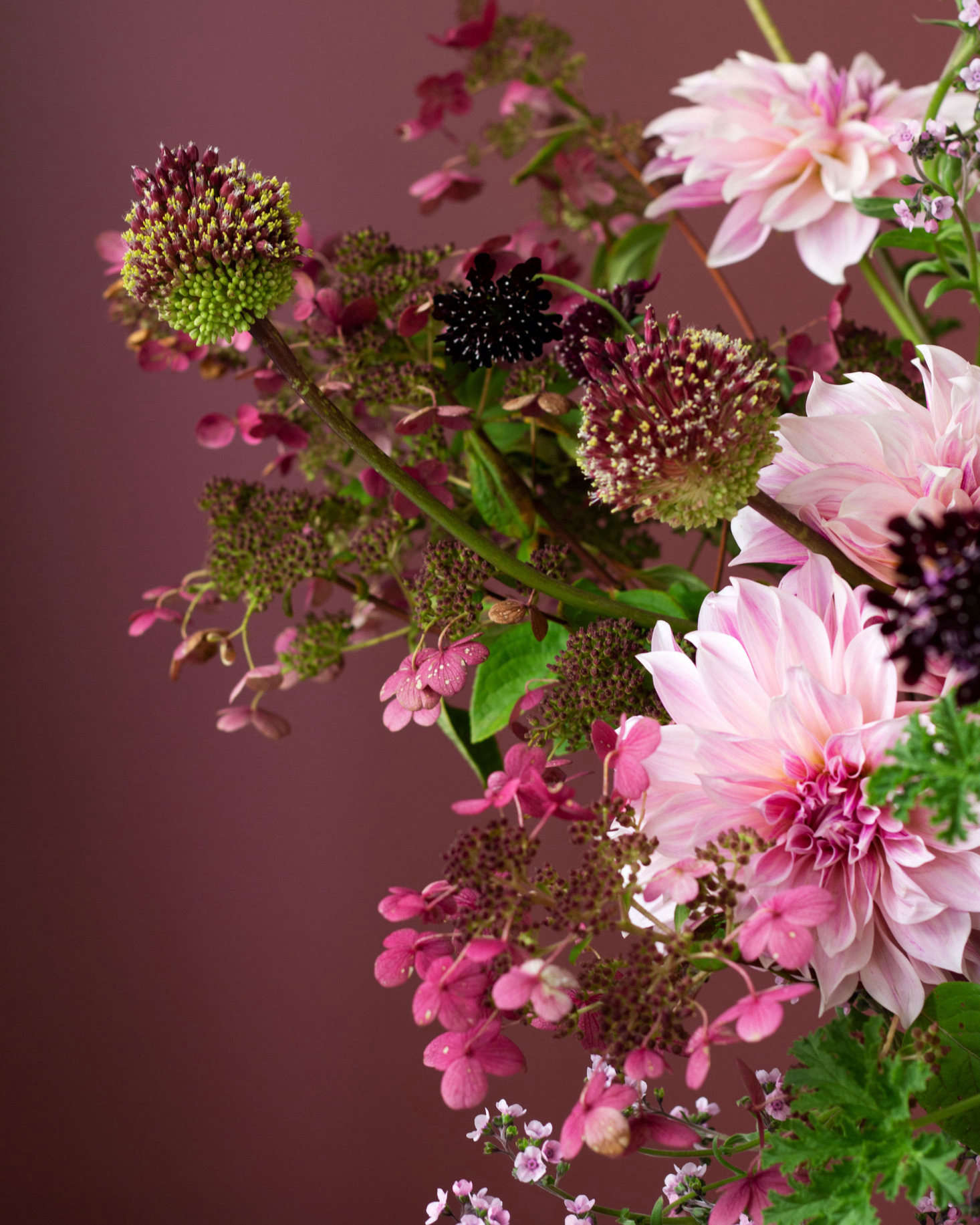 Pink and plum shades go especially well with the deep eggplant colors. This arrangement, by Susie Montagna, contains eggplants, scabiosa, dahlias, cosmos, allium, and more.