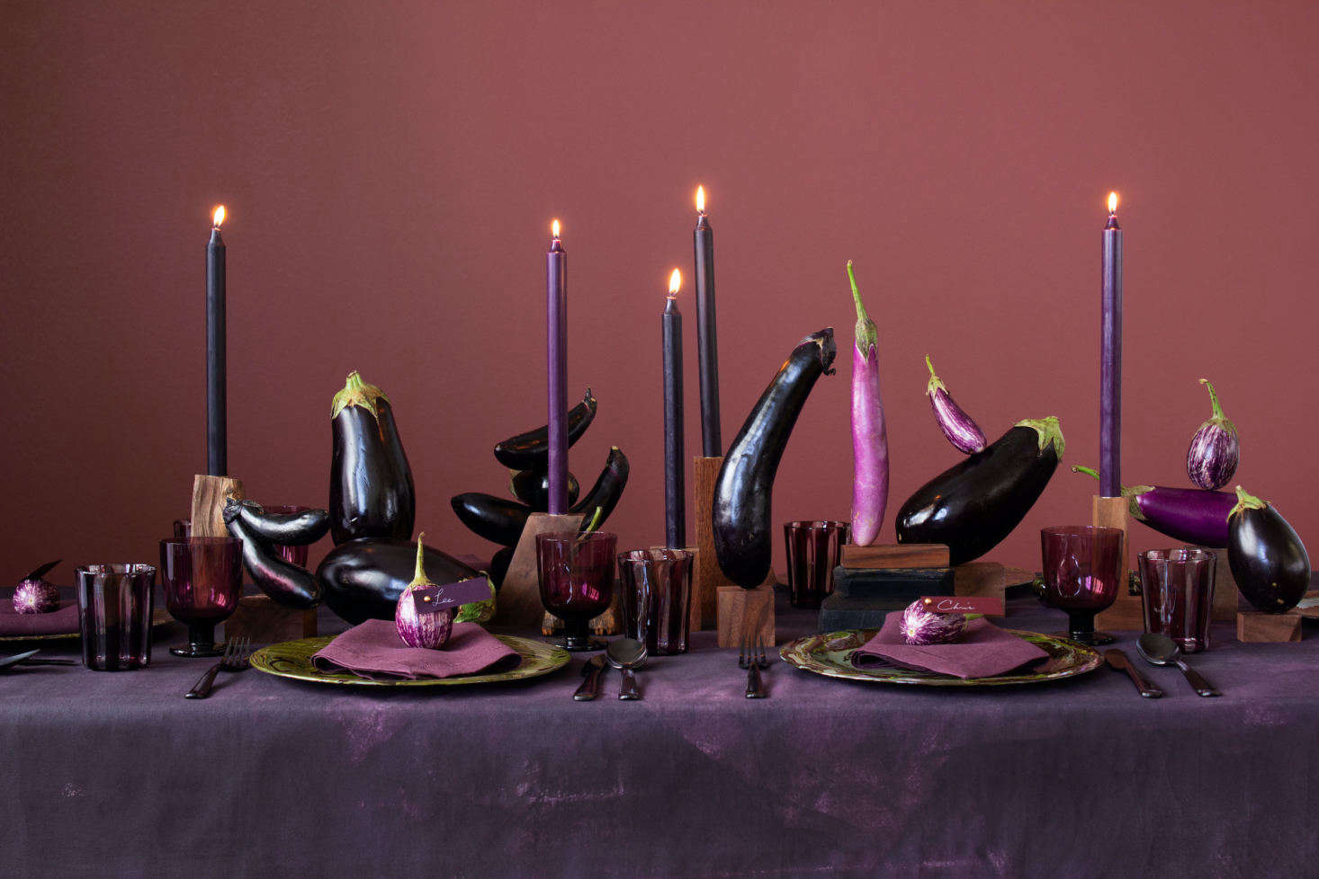 Eggplants alone can make for an arresting tablescape, especially when resting atop a DIY hand-painted purple canvas tablecloth.