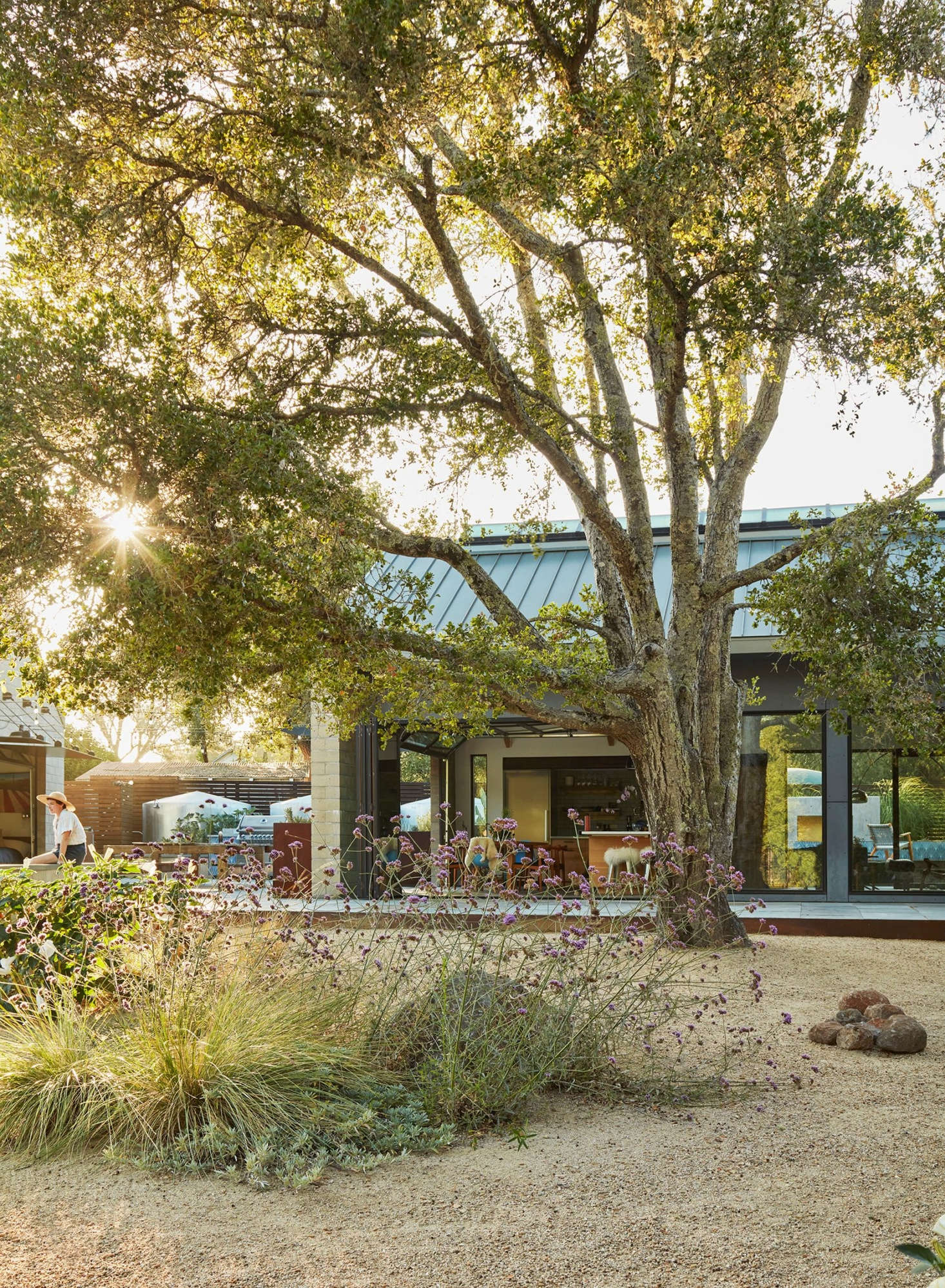 The glass doors of the kitchen fully open to bring the surroundings inside and vice versa. SkB Architects of Seattle designed the home, and Ironwood Builders built it.