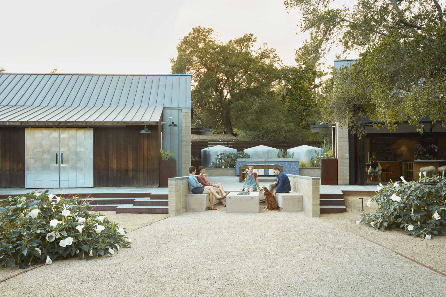 The patio shown above is in between the guest and main house. Story and her team cleverly made use of the water tanks in the design. “We used the emergency galvanized water tanks as a backdrop for a mix of xeric plants with an emphasis on form—spoon yucca and deer grass rub elbows with opuntia and sacred datura,” Story explains. (See The Garden Decoder: What Is 