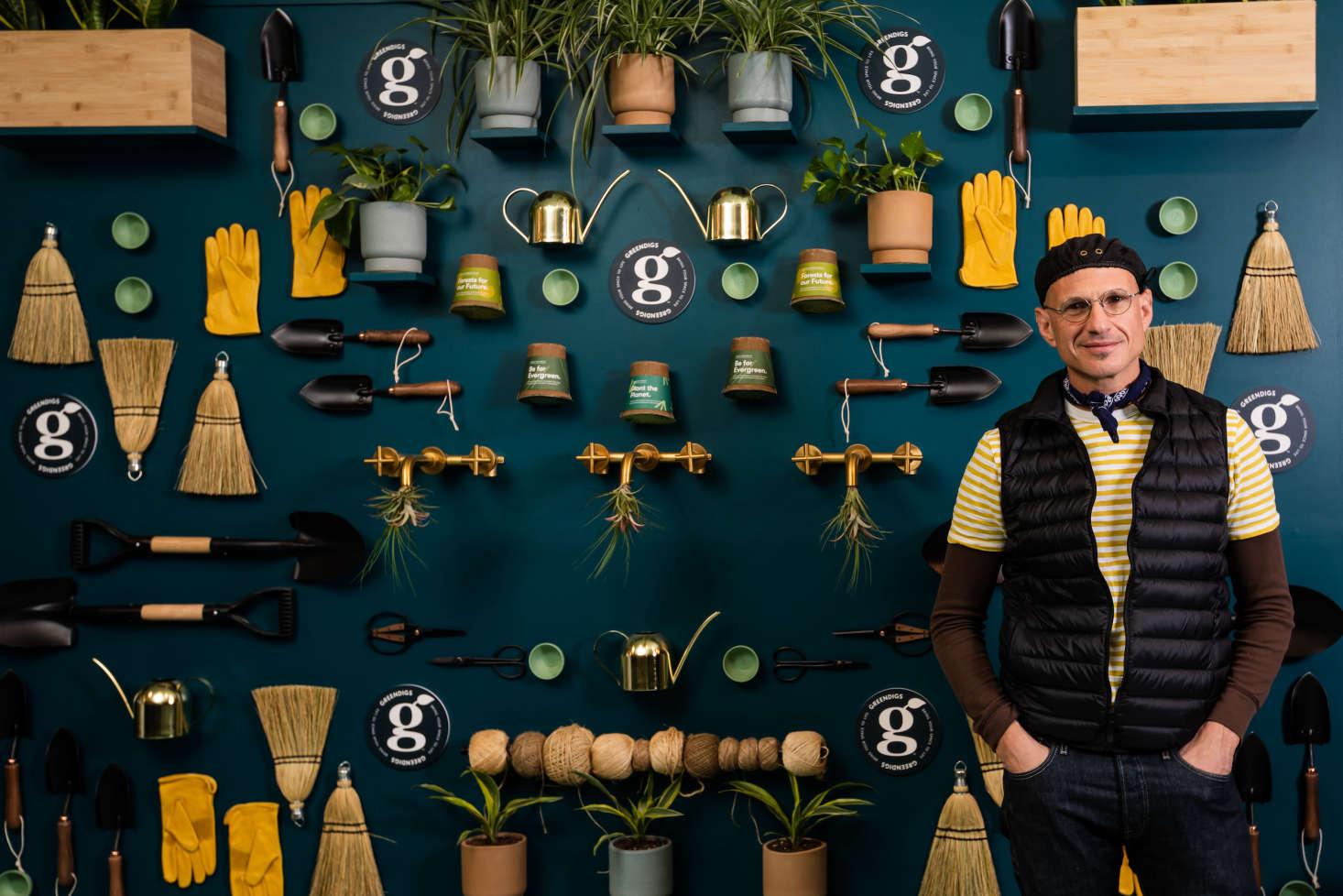 David in front of a display of some the products sold at Greendigs.