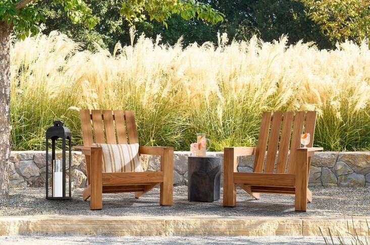 The Malibu Adirondack Chair is made from FSC-certified teak; \$\1,099 each or \$\1,798 for \2 at Pottery Barn.