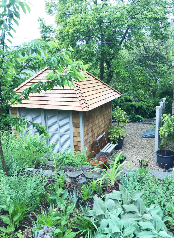 Growing in this terraced bed are catmint, forget-me-nots, and lambs ear. The shed below was built to house the couple&#8\2\17;s gardening tools and air conditioner compressor.