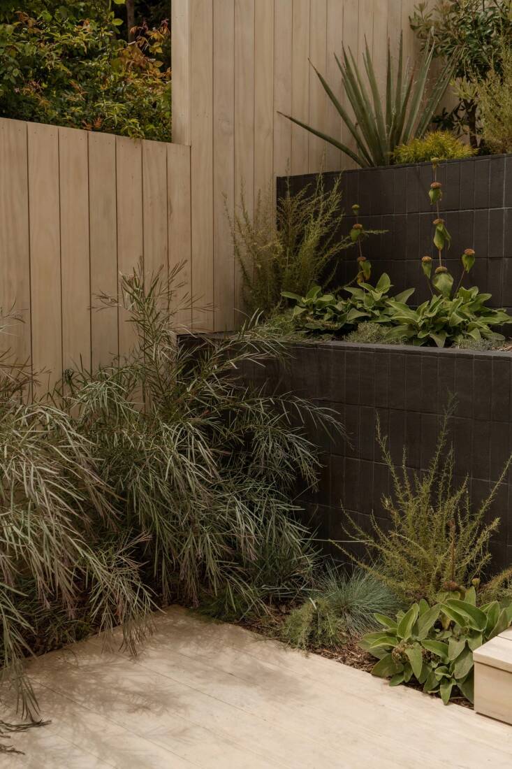 Thin Clay Pavers in Char make up the raised beds.